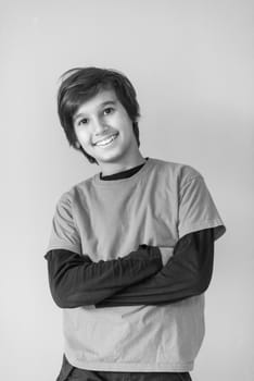 Portrait of a happy young boy in front of colored background