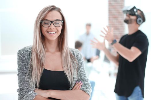 male and female application developers testing a new app designed for VR headset standing in modern office