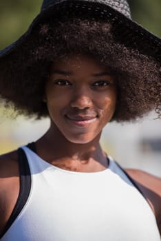 Close up portrait of a beautiful young african american woman smiling and looking up on a beautiful sunny day