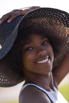 Close up portrait of a beautiful young african american woman smiling and looking up on a beautiful sunny day