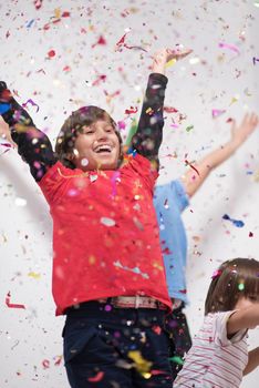 Happy kids celebrating party with blowing confetti