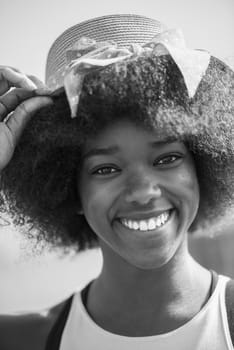 Close up portrait of a beautiful young african american woman smiling and looking up on a beautiful sunny day