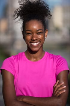 portrait of a young African American girl to run beautiful summer morning on city streets