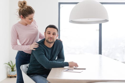 Portrait of a happy young beautiful couple hugging in their new home