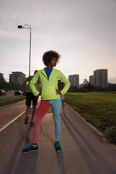 portrait of a young African American girl to run beautiful summer morning on city streets