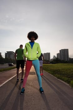 portrait of a young African American girl to run beautiful summer morning on city streets