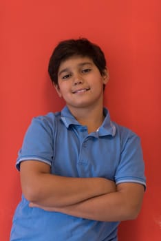 Portrait of a happy young boy in front of colored background