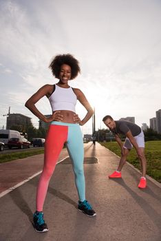 multiethnic group of young people on the jogging beautiful morning as the sun rises in the streets of the city