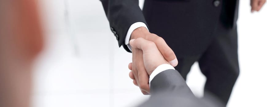 Cropped image of business people shaking hands in creative office