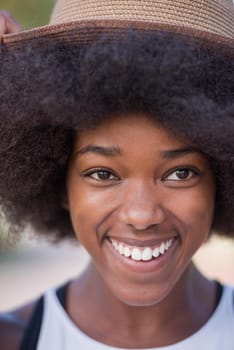 Close up portrait of a beautiful young african american woman smiling and looking up on a beautiful sunny day