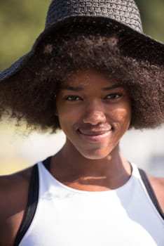 Close up portrait of a beautiful young african american woman smiling and looking up on a beautiful sunny day