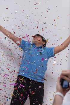 Happy kid celebrating party with blowing confetti