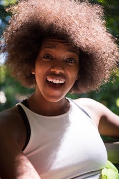 Close up portrait of a beautiful young african american woman smiling and looking up on a beautiful sunny day