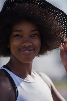 Close up portrait of a beautiful young african american woman smiling and looking up on a beautiful sunny day