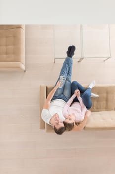 top view of Young couple on the sofa watching television together at home