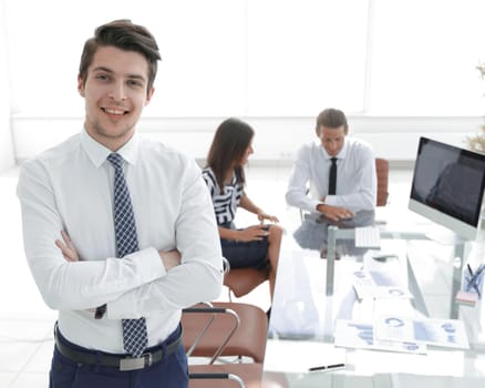 successful businessman on background of office.photo with copy space