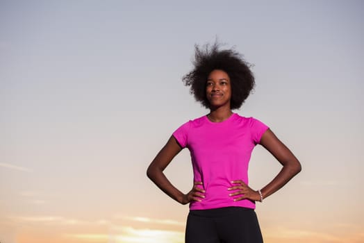 portrait of a young African American girl to run beautiful summer evening on city streets