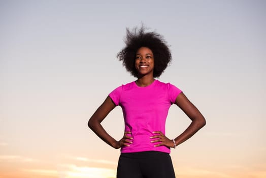 portrait of a young African American girl to run beautiful summer evening on city streets