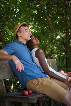 a young man and a beautiful African American girl enjoying a bike ride in nature on a sunny summer day