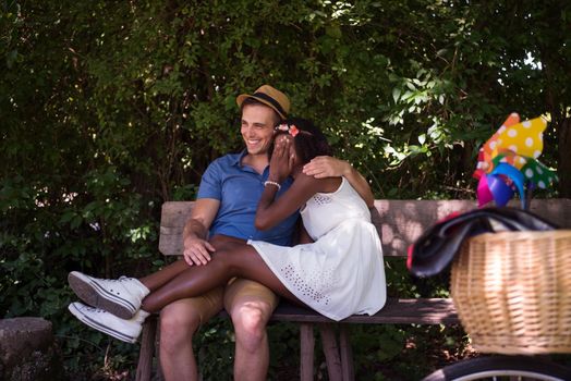 a young man and a beautiful African American girl enjoying a bike ride in nature on a sunny summer day