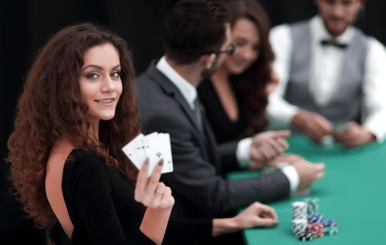 beautiful woman showing a combination of four aces. casino and lifestyle