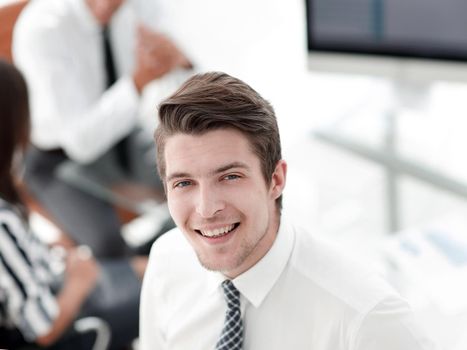 young employee of the company on the background of the office