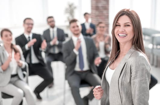 young business woman on the background of applauding business team.photo with copy space