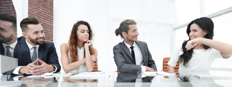 business team discusses the presentation,sitting behind a Desk in the office