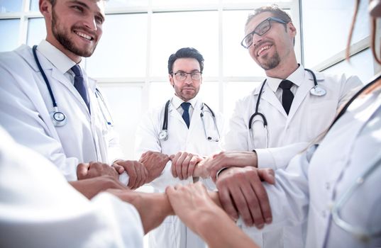 close up.a group of doctors standing in a circle . the concept of teamwork