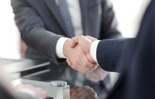 closeup.handshake of business partners after signing the contract.