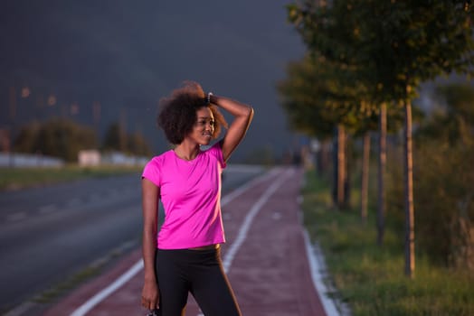 portrait of a young African American girl to run beautiful summer evening on city streets