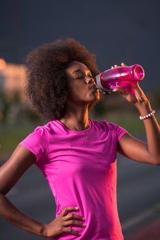 portrait of a young African American girl to run beautiful summer evening on city streets