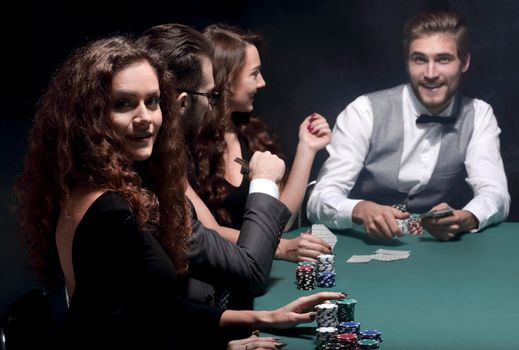 closeup.poker players sitting at a casino table . the concept of luck.