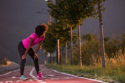 portrait of a young African American girl to run beautiful summer evening on city streets