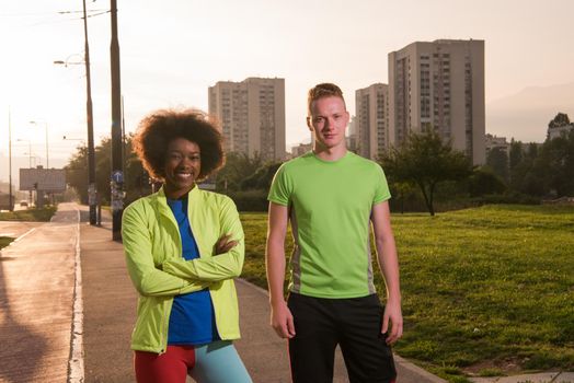 portrait of a young African American beautiful woman and a young man jogging in the city