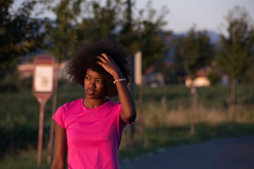 portrait of a young African American girl to run beautiful summer evening on city streets