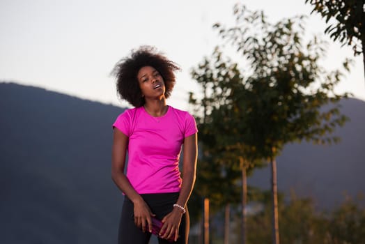 portrait of a young African American girl to run beautiful summer evening on city streets