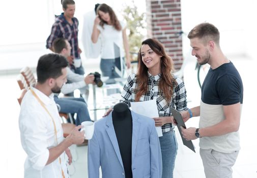 group of designers discuss men's suit in the Studio .