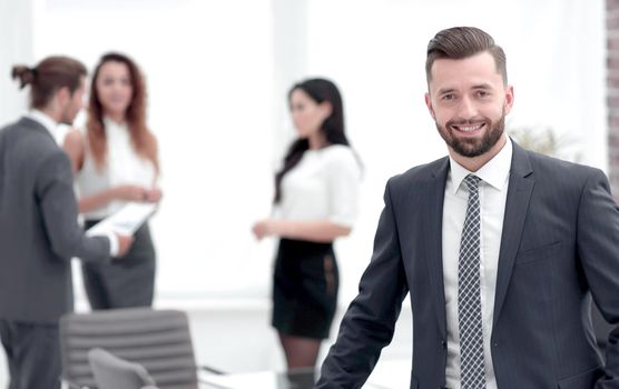 portrait of confident businessman on background of business team.