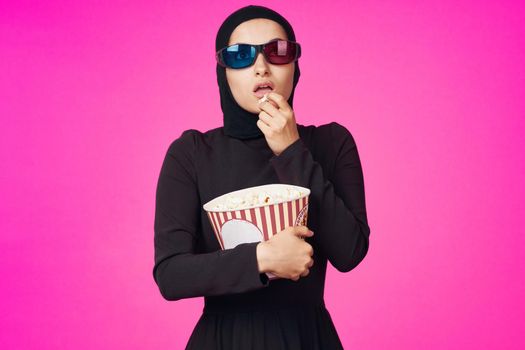 arab woman entertainment cinema popcorn fashion purple background. High quality photo