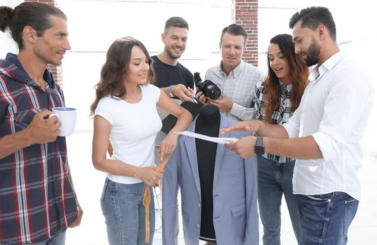 group of designers working with new models of men's clothing. photo with copy space