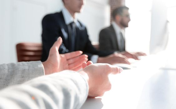 closeup. business team sitting at their Desk.business background