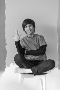 Portrait of a happy young boy in front of colored background