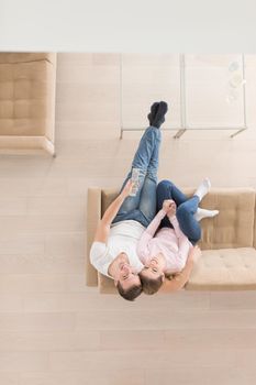 top view of Young couple on the sofa watching television together at home