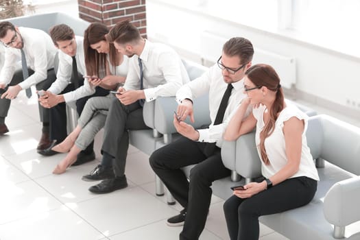 business team sitting in the lobby of the business center .business concept