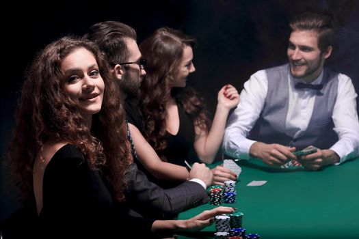closeup.poker players sitting at a casino table . the concept of luck.