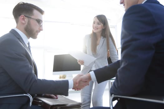 business handshake in an office. the concept of partnership.