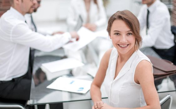 smiling business woman sitting in front of Desk.the concept of teamwork