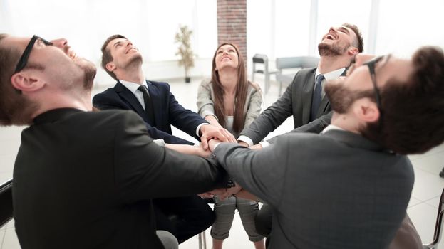 team of like-minded people sitting at the Desk and looking up.vision for the future