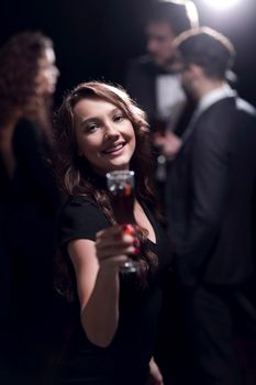 happy young woman raising glass in toast.the holidays and events